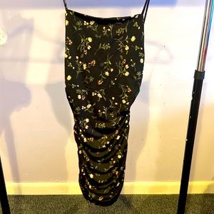 Black dress with flowers design in it. New. Has tag on it